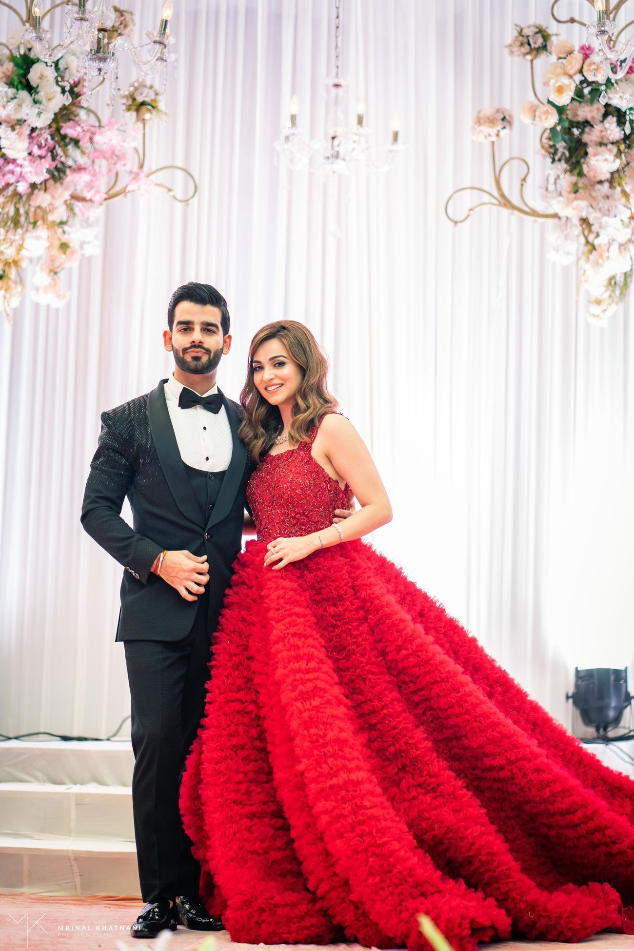 red gown with feathers for reception party for bride