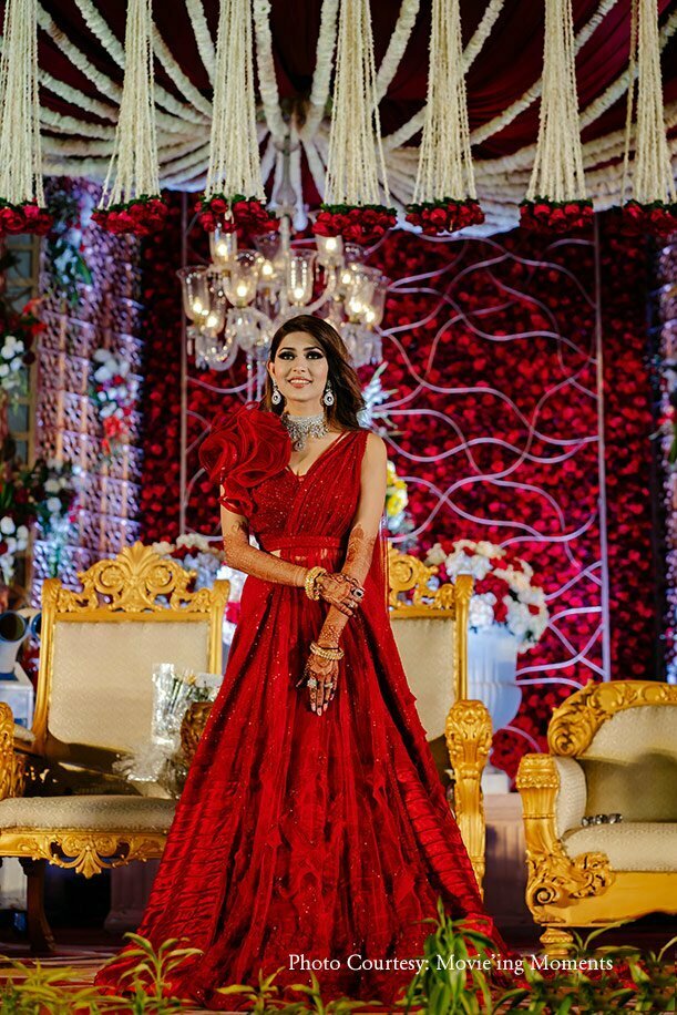 unique red wedding reception lehenga for bride with statement blouse and belt 