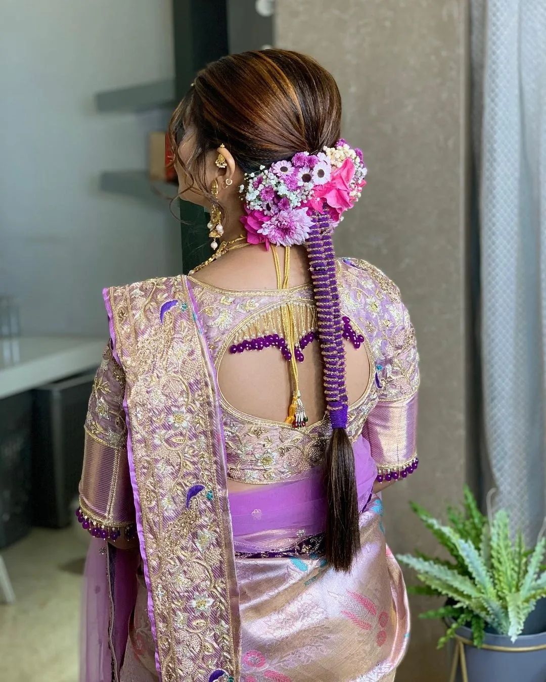 unique braid and flowers hairstyle for reception with saree
