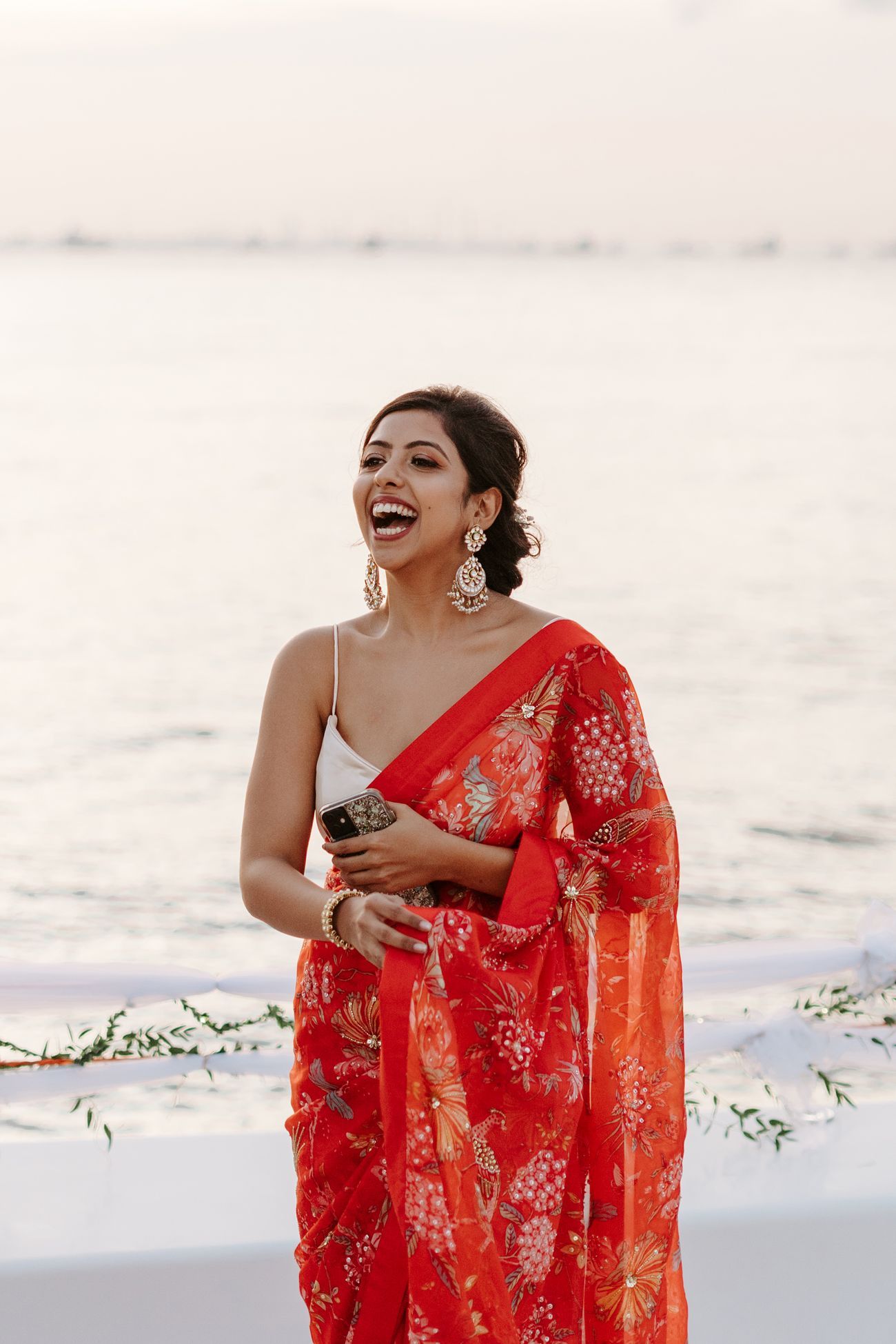 red printed saree with strappy white blouse