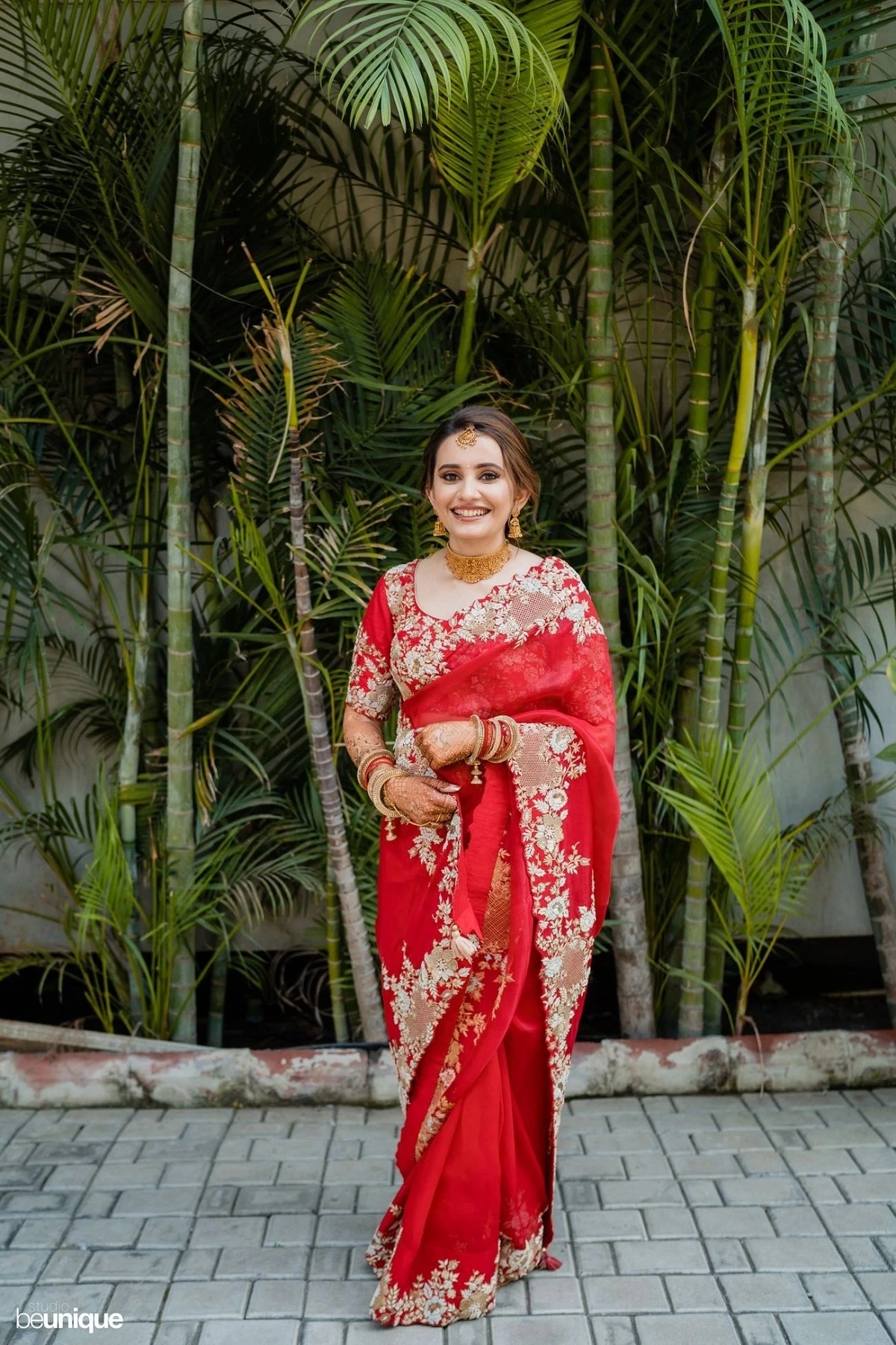 fancy red wedding saree with white floral border