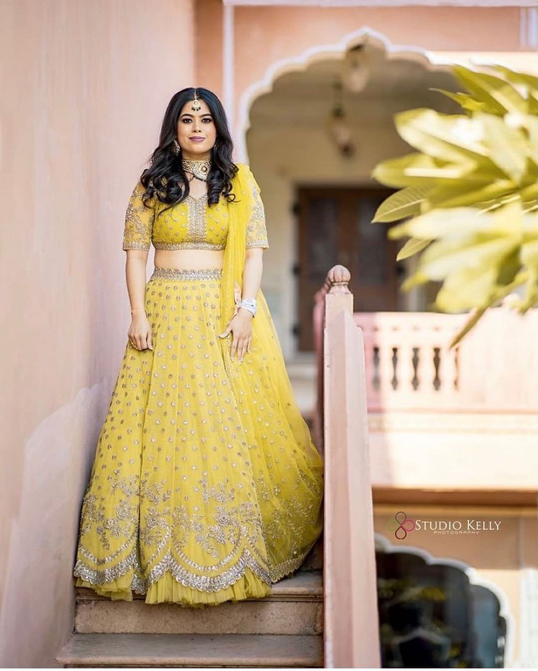 bride wearing yellow lehenga choli on haldi