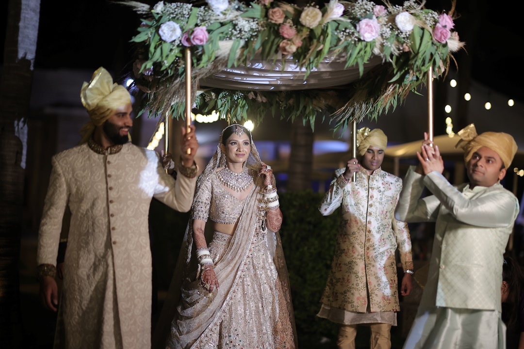 Kashish walking down the aisle during her beach wedding in Thailand