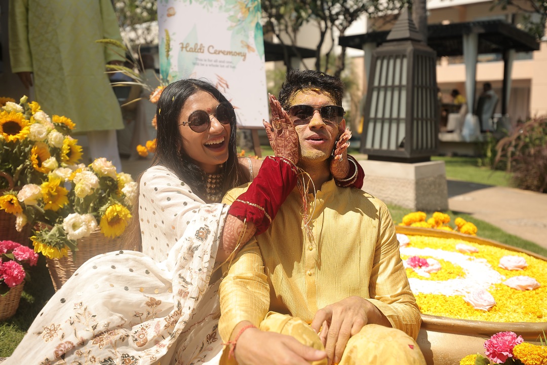 Kashish and Aseem during their haldi ceremony in white and yellow outfits