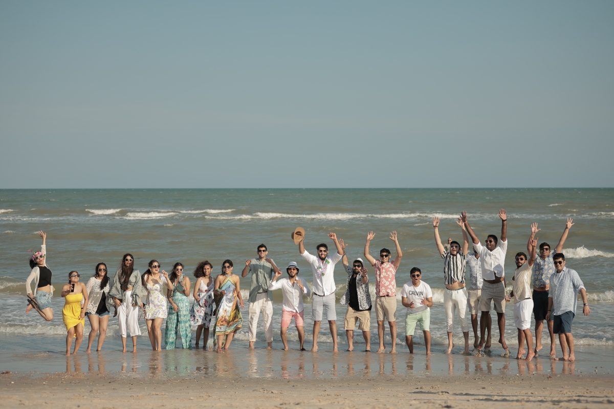 Kashish and Aseem on beach with friends at their pool party