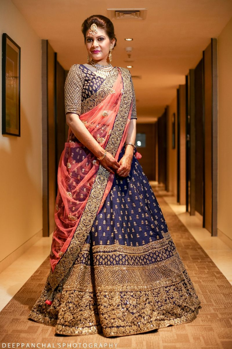 heavy embroidered blue and peach lehenga in contrast