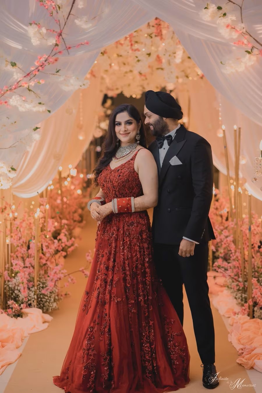 reception bride in designer red gown with embroidery work