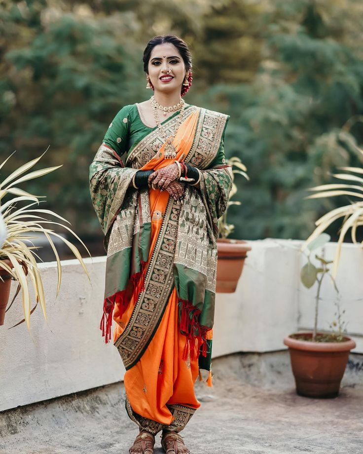 maharashtrian bride in traditional orange wedding nauvari saree and green shela