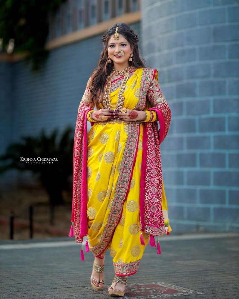 yellow wedding nauvari saree with open hair and pink shela