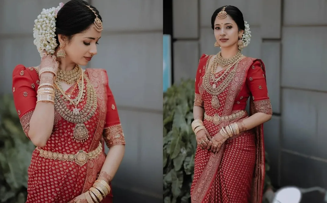 traditional kerala bride in red saree and layered gold jewellery