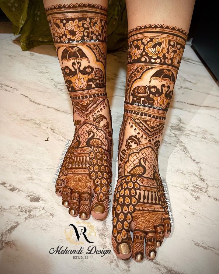 royal and stylish foot mehndi design with elephant and peacock motifs