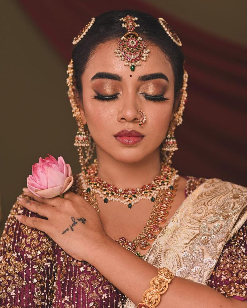 south indian bridal makeup image featuring bronze eyes and glossy lip