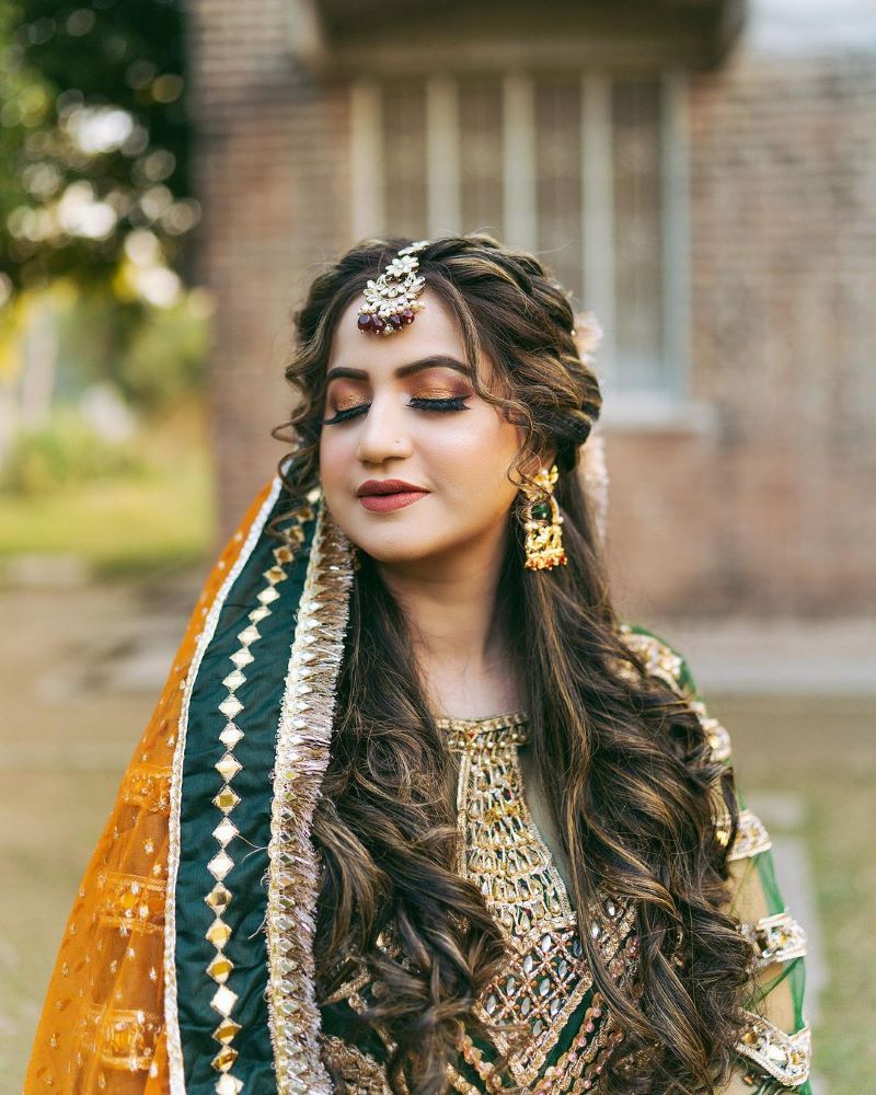 pakistani bridal hairstyle with braided crown and curls