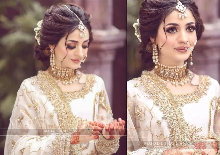 pakistani bridal hairstyles for walima with floral bun updo