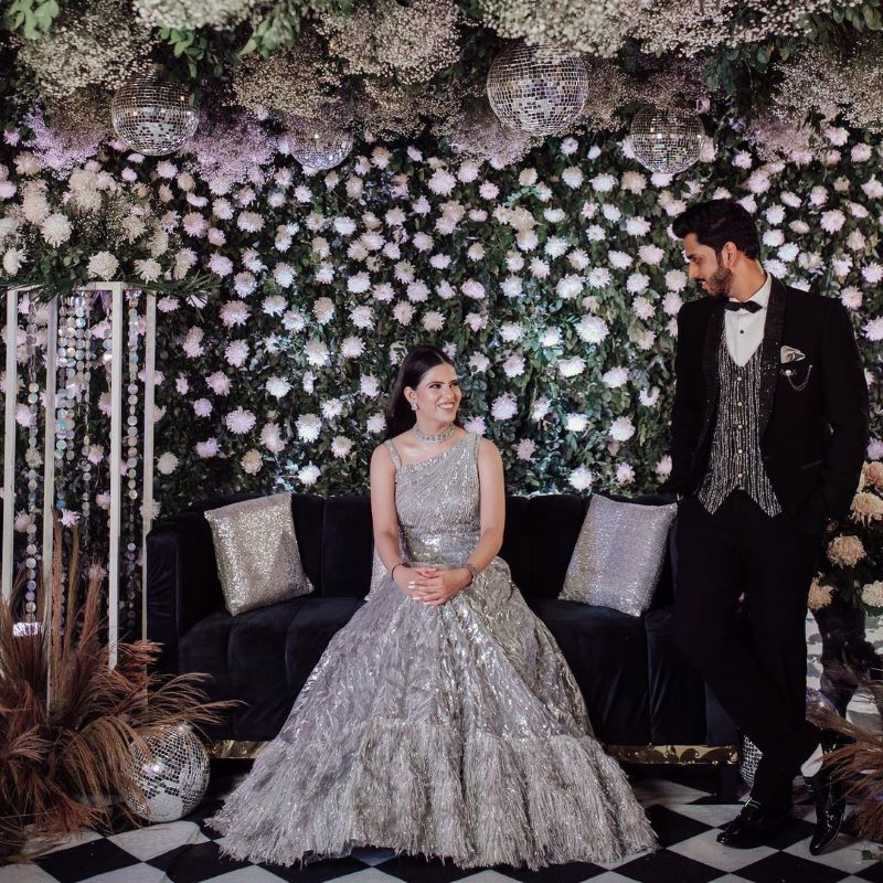 shimmery decoration for engagement stage with disco balls and white flowers
